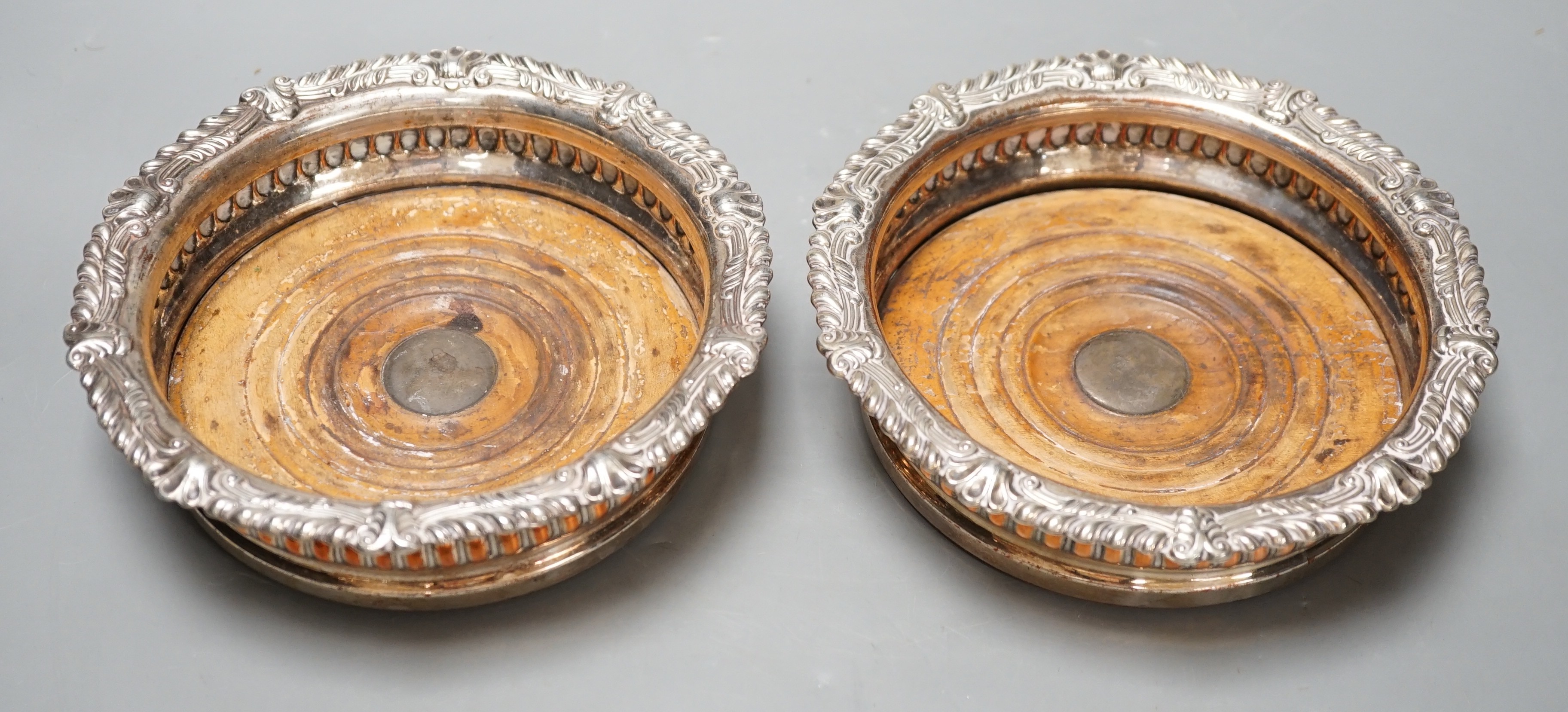 A pair of Regency Old Sheffield plate decanter coasters. 17cm diameter.